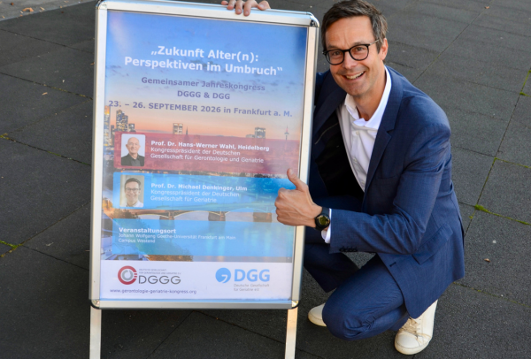 Professor Michael Denkinger präsentiert das Plakat zum großen Gerontologie- und Geriatrie-Kongress 2026. Denkinger ist neben Professor Hans-Werner Wahl Kongresspräsident für die kommende Jahrestagung von DGG und DGGG in Frankfurt am Main.